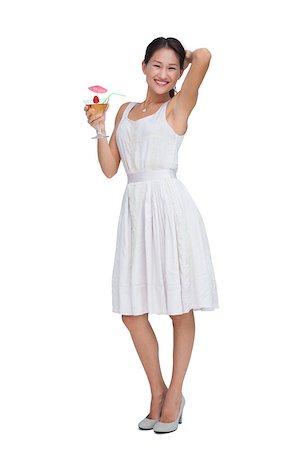 fresh-faced - Happy brunette posing with cocktail against white background Stock Photo - Budget Royalty-Free & Subscription, Code: 400-06932503