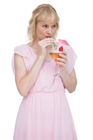 fresh-faced - Attractive blonde drinking cocktail against white background Stock Photo - Budget Royalty-Free & Subscription, Code: 400-06932539