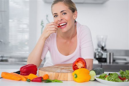 simsearch:400-06891385,k - Attractive woman eating vegetables and looking at camera Stock Photo - Budget Royalty-Free & Subscription, Code: 400-06932555