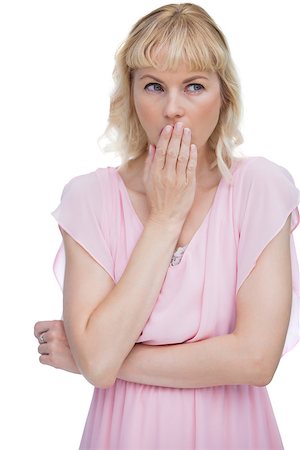 fresh-faced - Blond woman putting her hand on her mouth on white background Stock Photo - Budget Royalty-Free & Subscription, Code: 400-06932550