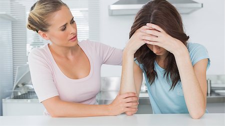 friends home upset - Woman in the kitchen comforting her upset friend Stock Photo - Budget Royalty-Free & Subscription, Code: 400-06932629