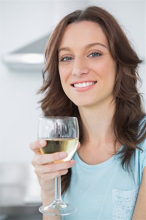 simsearch:400-06932687,k - Brunette in her kitchen having a glass of white wine Stock Photo - Budget Royalty-Free & Subscription, Code: 400-06932678