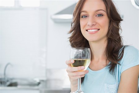 simsearch:400-06932687,k - Pretty brunette in her kitchen having a glass of wine Stock Photo - Budget Royalty-Free & Subscription, Code: 400-06932679