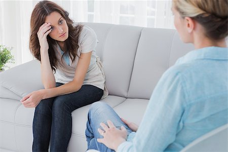 simsearch:400-06932773,k - Upset woman sitting on the couch and looking at therapist in a private session Stock Photo - Budget Royalty-Free & Subscription, Code: 400-06932738