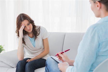 simsearch:400-06932773,k - Worried woman sitting while therapist looking at her in a private session Stock Photo - Budget Royalty-Free & Subscription, Code: 400-06932733