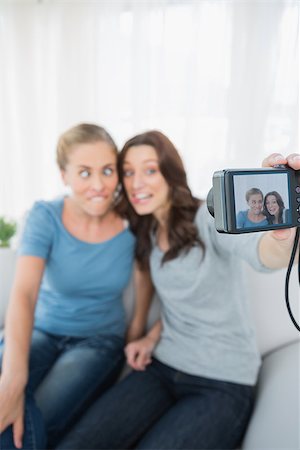 simsearch:400-07059986,k - Women making faces while taking pictures of themselves at home Stock Photo - Budget Royalty-Free & Subscription, Code: 400-06932847