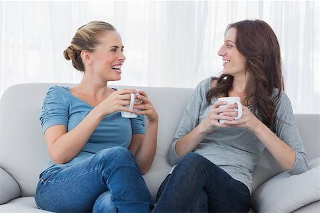 simsearch:400-07059986,k - Friends having coffee and looking at each other sitting on the couch Stock Photo - Budget Royalty-Free & Subscription, Code: 400-06932849