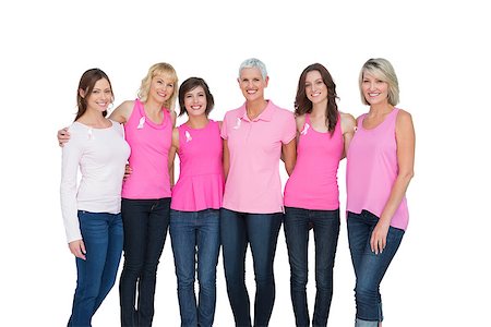 simsearch:400-06932882,k - Smiling women wearing pink for breast cancer awareness on white background Stock Photo - Budget Royalty-Free & Subscription, Code: 400-06932870