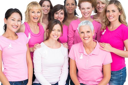 simsearch:400-06932887,k - Voluntary pretty women posing and wearing pink for breast cancer on white background Fotografie stock - Microstock e Abbonamento, Codice: 400-06932888