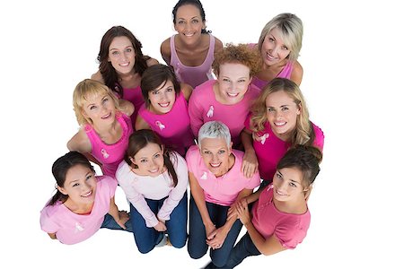 simsearch:400-06932887,k - Cheerful women looking up wearing pink for breast cancer on white background Fotografie stock - Microstock e Abbonamento, Codice: 400-06932898