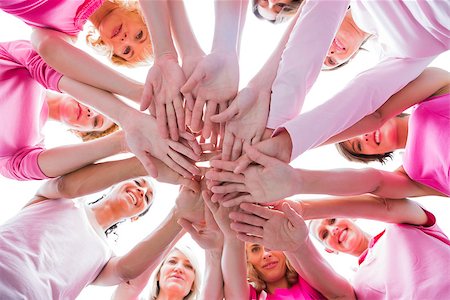 simsearch:400-06932887,k - Diverse women smiling in circle wearing pink for breast cancer on white background Fotografie stock - Microstock e Abbonamento, Codice: 400-06932893