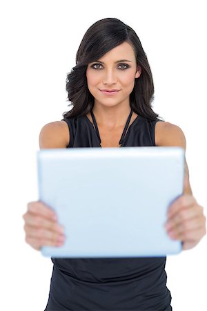 simsearch:614-06897320,k - Peaceful elegant brown haired model holding tablet in front of her on white background Foto de stock - Super Valor sin royalties y Suscripción, Código: 400-06933267