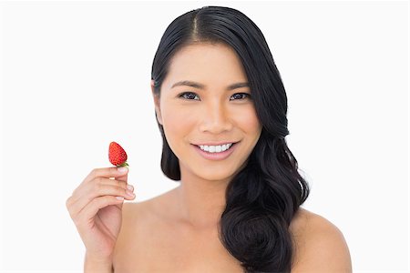 simsearch:693-06021794,k - Natural brown haired model holding strawberry on white background Stock Photo - Budget Royalty-Free & Subscription, Code: 400-06933770