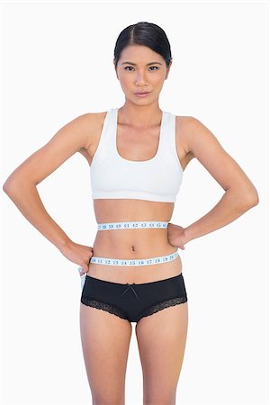 simsearch:400-04955629,k - Slim woman measuring her waist on white background Stock Photo - Budget Royalty-Free & Subscription, Code: 400-06933824