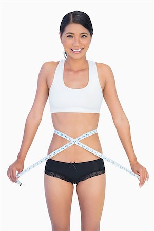 simsearch:400-04955629,k - Cheerful slim woman measuring her waist on white background Stock Photo - Budget Royalty-Free & Subscription, Code: 400-06933829