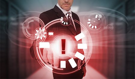 simsearch:400-06886789,k - Businessman touching red futuristic warning icon interface in data center Stock Photo - Budget Royalty-Free & Subscription, Code: 400-06933873