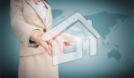 simsearch:400-06890406,k - Businesswoman touching house graphic on world map background Stock Photo - Budget Royalty-Free & Subscription, Code: 400-06933913