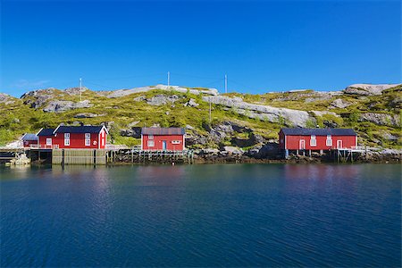 simsearch:400-06946273,k - Red fishing rorbu huts by the fjord on Lofoten islands in Norway during summer Photographie de stock - Aubaine LD & Abonnement, Code: 400-06945546