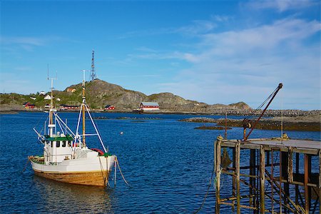 Traditional norwegian fishing boat by pier on Lofoten islands in Norway Foto de stock - Super Valor sin royalties y Suscripción, Código: 400-06945657