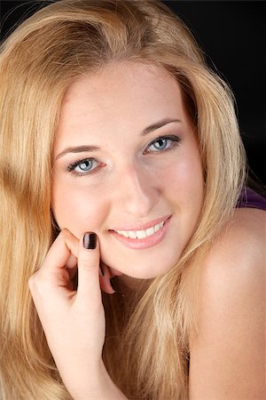 simsearch:400-04363188,k - Portrait of the girl close up on a black background. She joyfully smiles in the camera. Stock Photo - Budget Royalty-Free & Subscription, Code: 400-06946784
