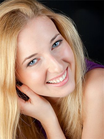 simsearch:400-04363188,k - Portrait of the girl close up on a black background. She joyfully smiles in the camera. Stock Photo - Budget Royalty-Free & Subscription, Code: 400-06946785