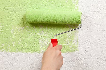 simsearch:400-04349276,k - A painter is holding a paint roller in his hand and paints a wall Stock Photo - Budget Royalty-Free & Subscription, Code: 400-06947018