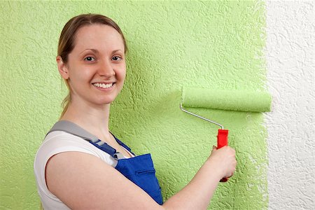 simsearch:400-04349276,k - Young woman painting a wall with a paint roller Stock Photo - Budget Royalty-Free & Subscription, Code: 400-06947019