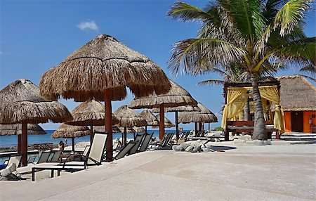 resort outdoor bed - Beach on the seashore with umbrellas from straw, tents and plank beds for suntan Stock Photo - Budget Royalty-Free & Subscription, Code: 400-06947087