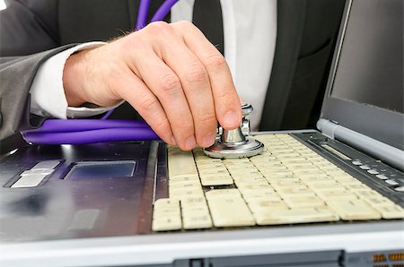 simsearch:400-05244427,k - Repairman checking old and dirty laptop with stethoscope. Stock Photo - Budget Royalty-Free & Subscription, Code: 400-06947264