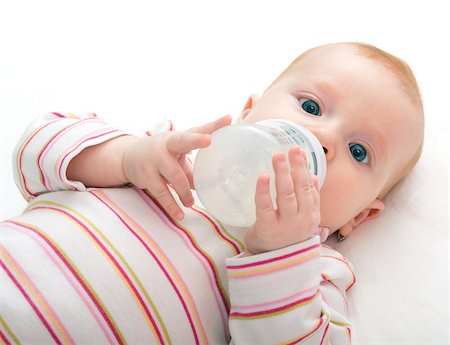 simsearch:400-06073989,k - Baby Girl Drinking Milk from Bottle on White Background - Shallow Depth of Field Photographie de stock - Aubaine LD & Abonnement, Code: 400-06947499