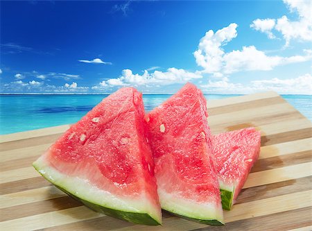 red water melon - Watermelon slices on sea background - summer and travel concept Photographie de stock - Aubaine LD & Abonnement, Code: 400-06947545