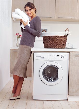 detergente - woman on washing machine in kitchen Foto de stock - Super Valor sin royalties y Suscripción, Código: 400-06947794
