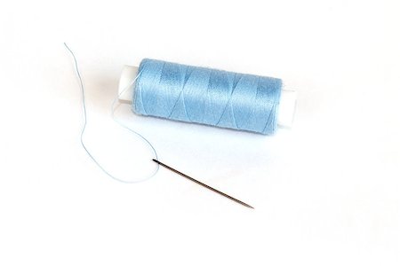 simsearch:400-05348474,k - Blue bobbin of thread with needle on white background Photographie de stock - Aubaine LD & Abonnement, Code: 400-06947968