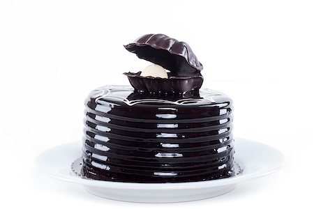 Chocolate cake with oyster shape decoration on white plate Stock Photo - Budget Royalty-Free & Subscription, Code: 400-06948124
