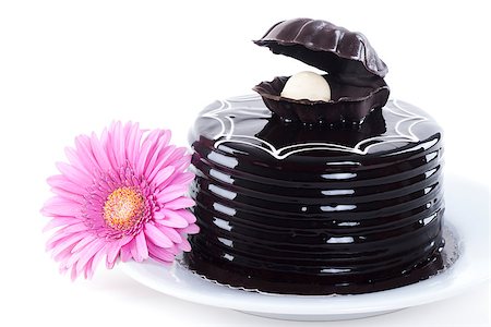 Chocolate cake and pink gerbera on white plate Stock Photo - Budget Royalty-Free & Subscription, Code: 400-06948125