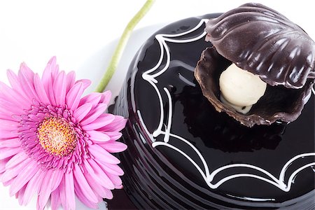 Chocolate cake and pink gerbera on white plate Stock Photo - Budget Royalty-Free & Subscription, Code: 400-06948126