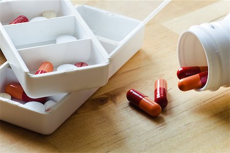 pillbox - Pills, capsules and tablets sorted in medicine box for use as daily medication Stock Photo - Budget Royalty-Free & Subscription, Code: 400-06948137