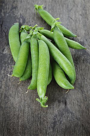 row of seeds - heap of fresh pea pods, on wood table Stock Photo - Budget Royalty-Free & Subscription, Code: 400-06948411