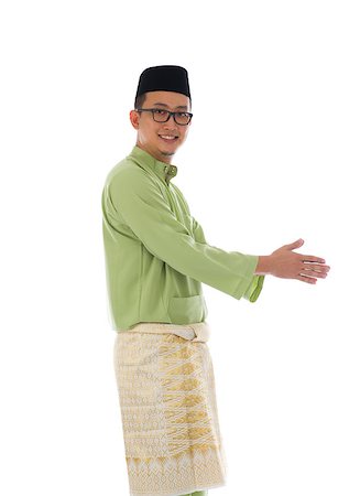 Traditonal Malay man with welcome gesture during ramadan isolated white background Stock Photo - Budget Royalty-Free & Subscription, Code: 400-06948592