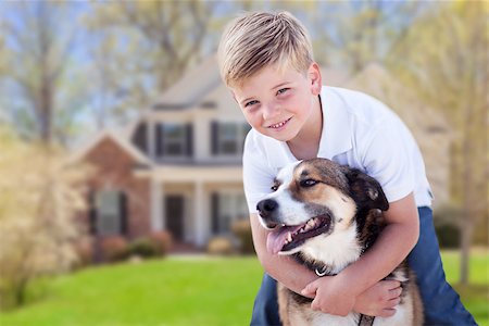 feverpitched (artist) - Happy Young Boy and His Dog in Front Yard of Their House. Foto de stock - Royalty-Free Super Valor e Assinatura, Número: 400-06948676