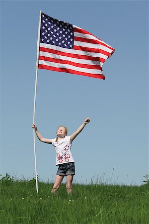 Patriotic young girl with american flag on green meadow Stock Photo - Budget Royalty-Free & Subscription, Code: 400-06948703