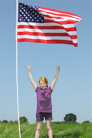 Patriotic young girl with american flag on green meadow Stock Photo - Budget Royalty-Free & Subscription, Code: 400-06948712