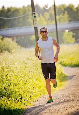 simsearch:400-07509642,k - A man running in the sunset Stock Photo - Budget Royalty-Free & Subscription, Code: 400-06948795