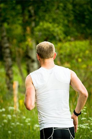 A man running on a green field Foto de stock - Royalty-Free Super Valor e Assinatura, Número: 400-06948796