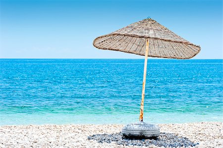 simsearch:400-06947087,k - lone wicker umbrella on the beach Stock Photo - Budget Royalty-Free & Subscription, Code: 400-06948832