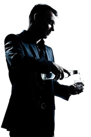 stylish man drinking alcohol - one caucasian man portrait pouring white alcohol silhouette in studio isolated white background Stock Photo - Budget Royalty-Free & Subscription, Code: 400-06949052