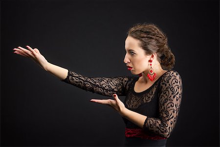 pictures of the traditional dance in spain - Flamenco dancer in black dress with red earrings Stock Photo - Budget Royalty-Free & Subscription, Code: 400-06949230
