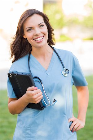 Portrait of An Attractive Young Adult Woman Doctor or Nurse Holding Touch Pad Outside. Stock Photo - Budget Royalty-Free & Subscription, Code: 400-06949706