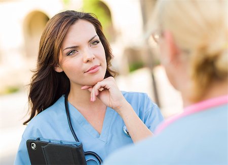 Two Young Adult Professional Female Doctors or Nuses Talking Outside. Stock Photo - Budget Royalty-Free & Subscription, Code: 400-06949707