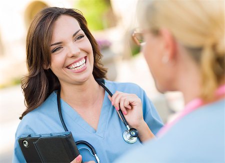 Two Young Adult Professional Female Doctors or Nuses Talking Outside. Stock Photo - Budget Royalty-Free & Subscription, Code: 400-06949708